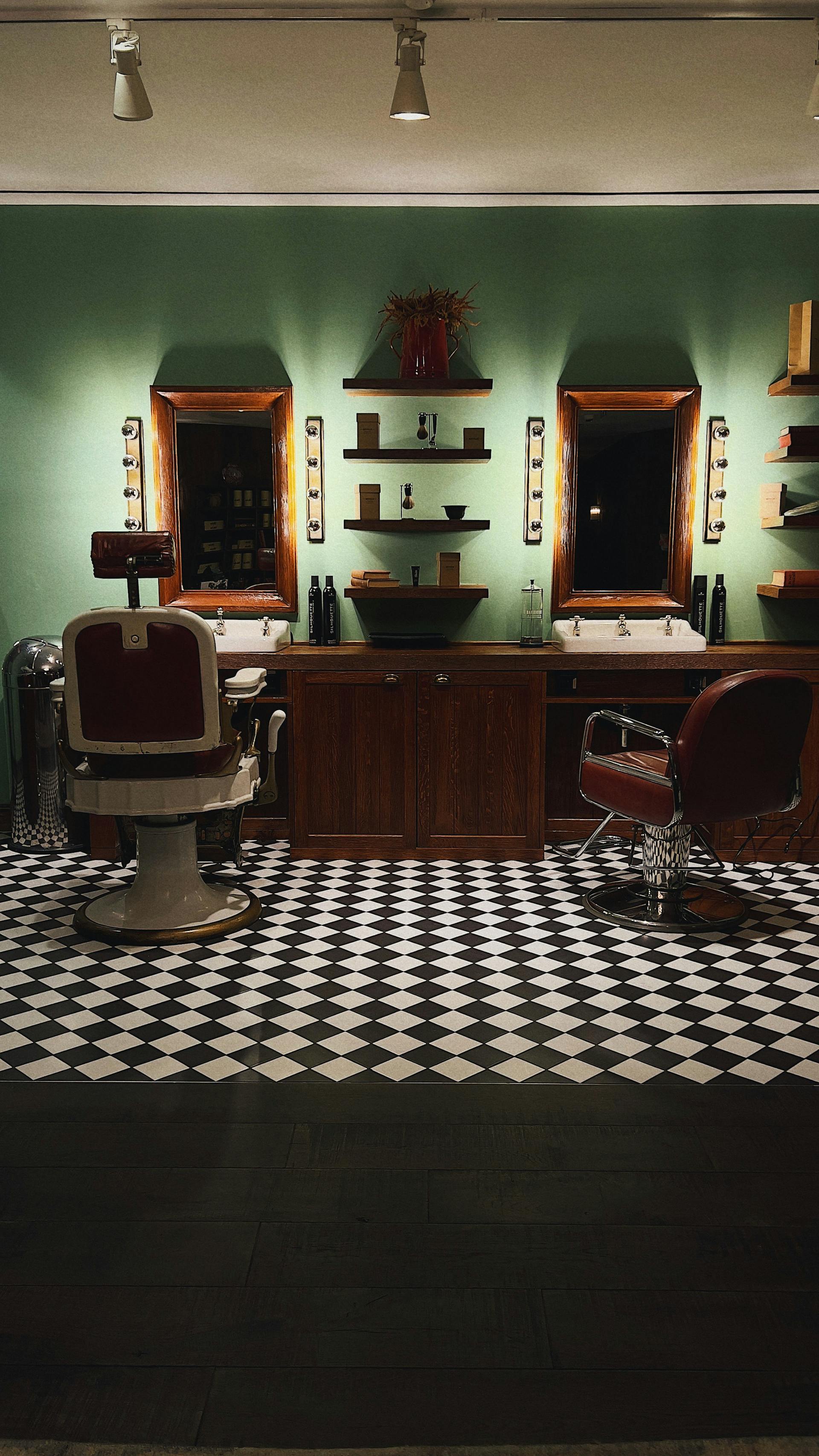 Kalm Grooming interior — leather chairs, copper light fixtures